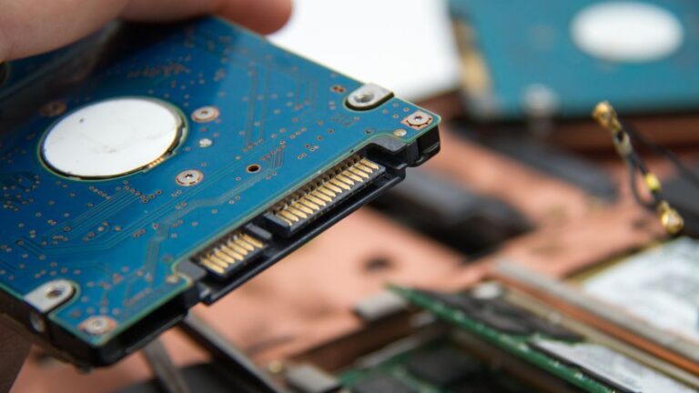 laptop repair and recovery technician working